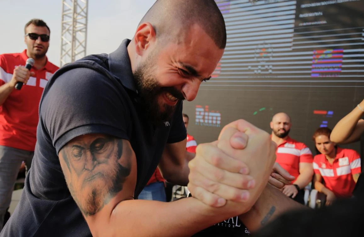 Lebanese men compete in an arm-wrestling championship in the coastal city of Jounieh on July 13, 2018. (AFP)