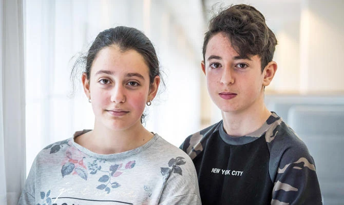 A photo taken on August 13, 2018 in The Hague shows two Armenian teens, Howick (R) and Lili, facing imminent expulsion from the Netherlands. (AFP)