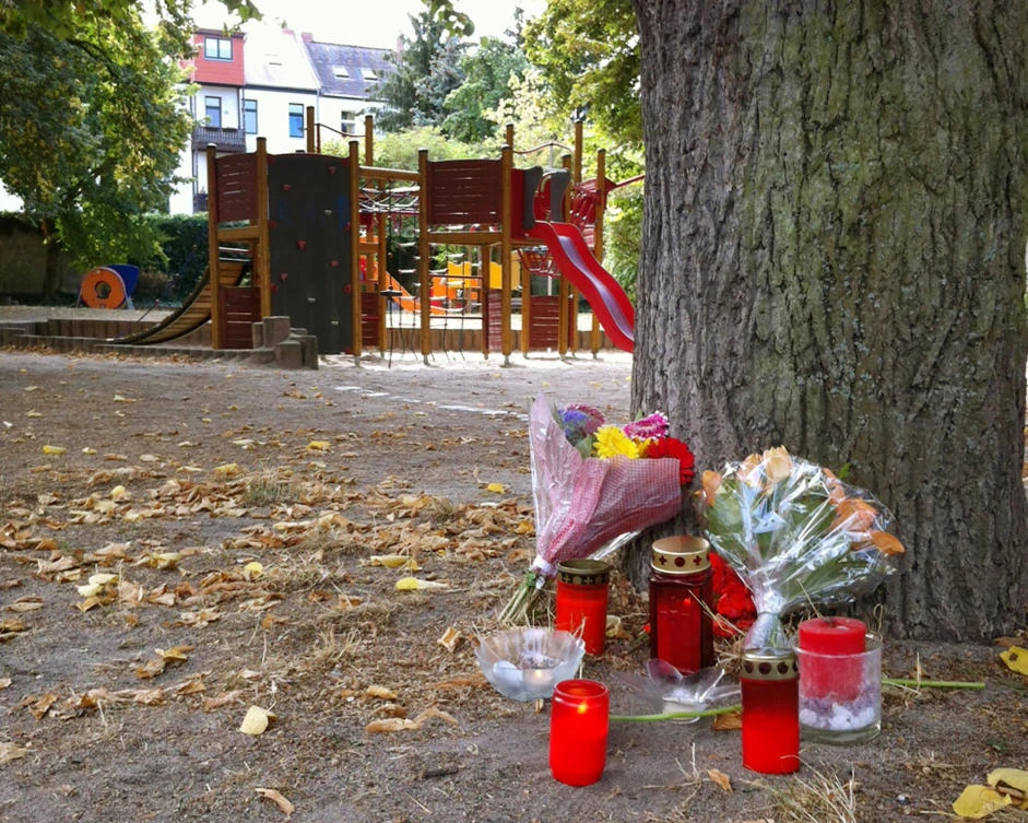 A picture taken on September 9, 2018 shows candles and folwers displayed at a playground after the killing of a 22-year-old German man in a fight in the German eastern town of Koethen. (AFP)