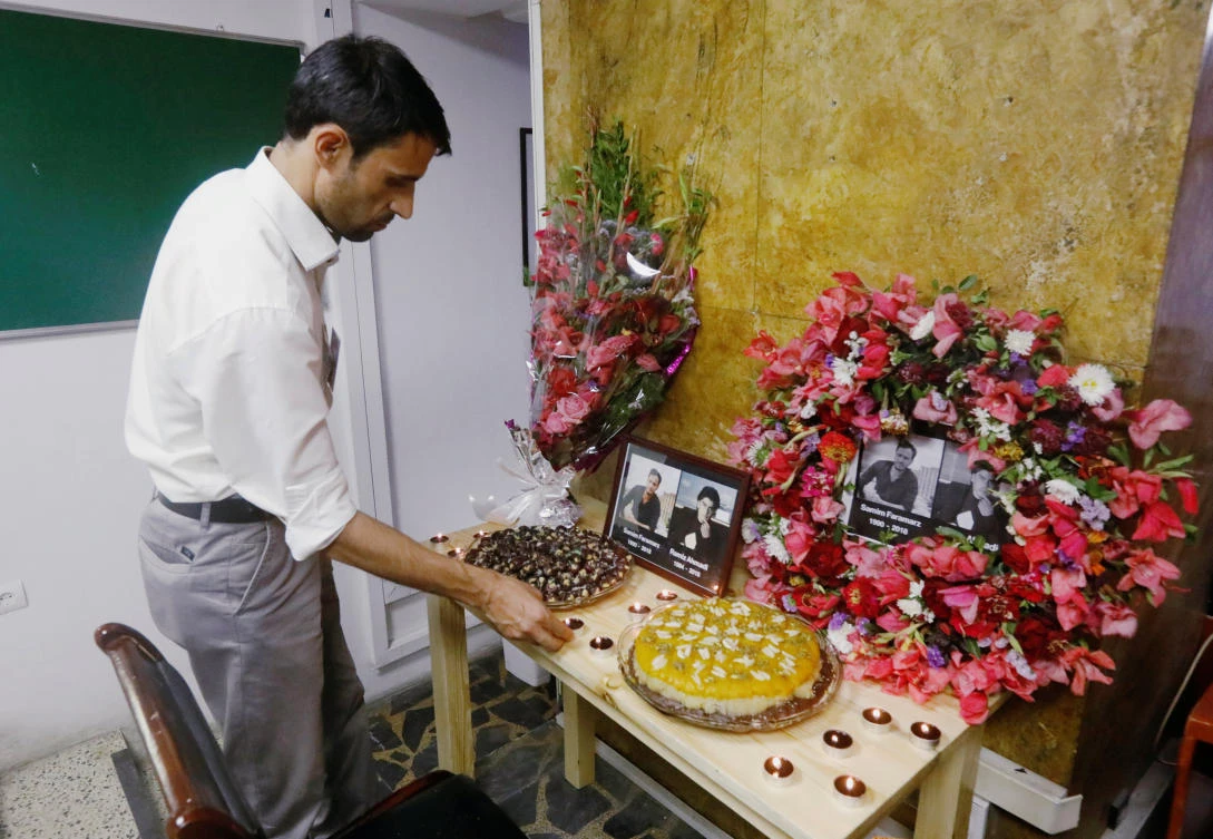 An Afghan journalist working for Tolo News lights candles in front of pictures of his colleagues who were killed in a suicide attack Kabul, Afghanistan September 7, 2018. Picture taken September 7, 2018. (Reuters)