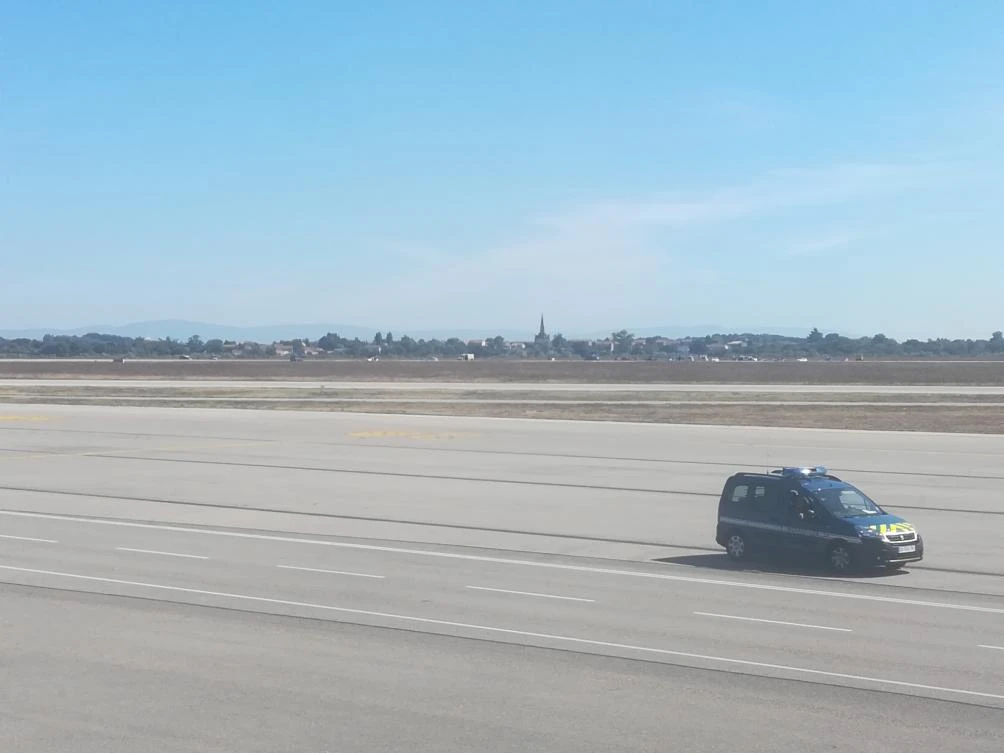 A French gendarmes vehicle speeds on the runway of Lyon’s Saint-Exupery airport on Sept. 10, 2018 as a man was arrested by the police after having managed to get in the runways with his car without doing any injury. (Jean Decotte/AFP)