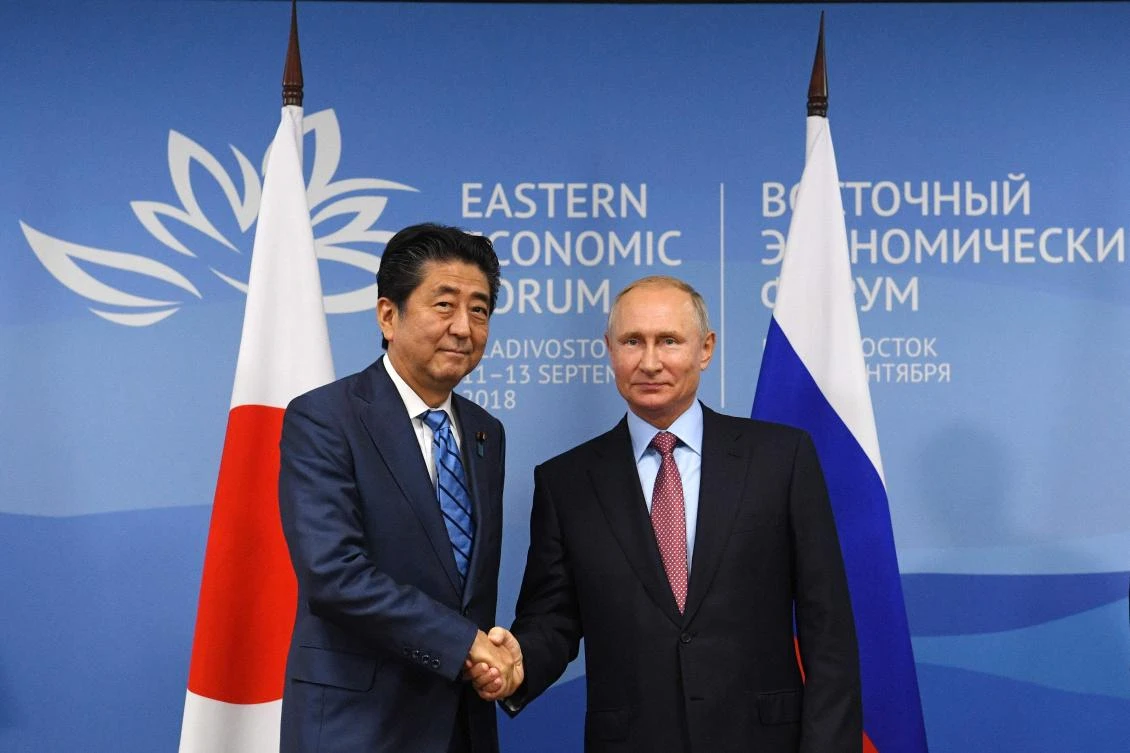 Russian President Vladimir Putin (R) shakes hands with Japanese Prime Minister Shinzo Abe during a meeting in Vladivostok on September 10, 2018. (AFP)