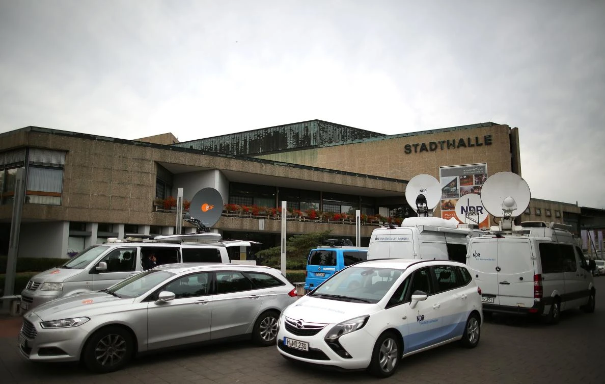 A picture taken on September 10, 2018 shows news vans parked outside the Stadthalle venue in Braunschweig, northern Germany, on the first day of the model case proceedings in Germany against German car maker Volkswagen (VW) over its cheating in emissions tests involving millions of diesel cars. (AFP)