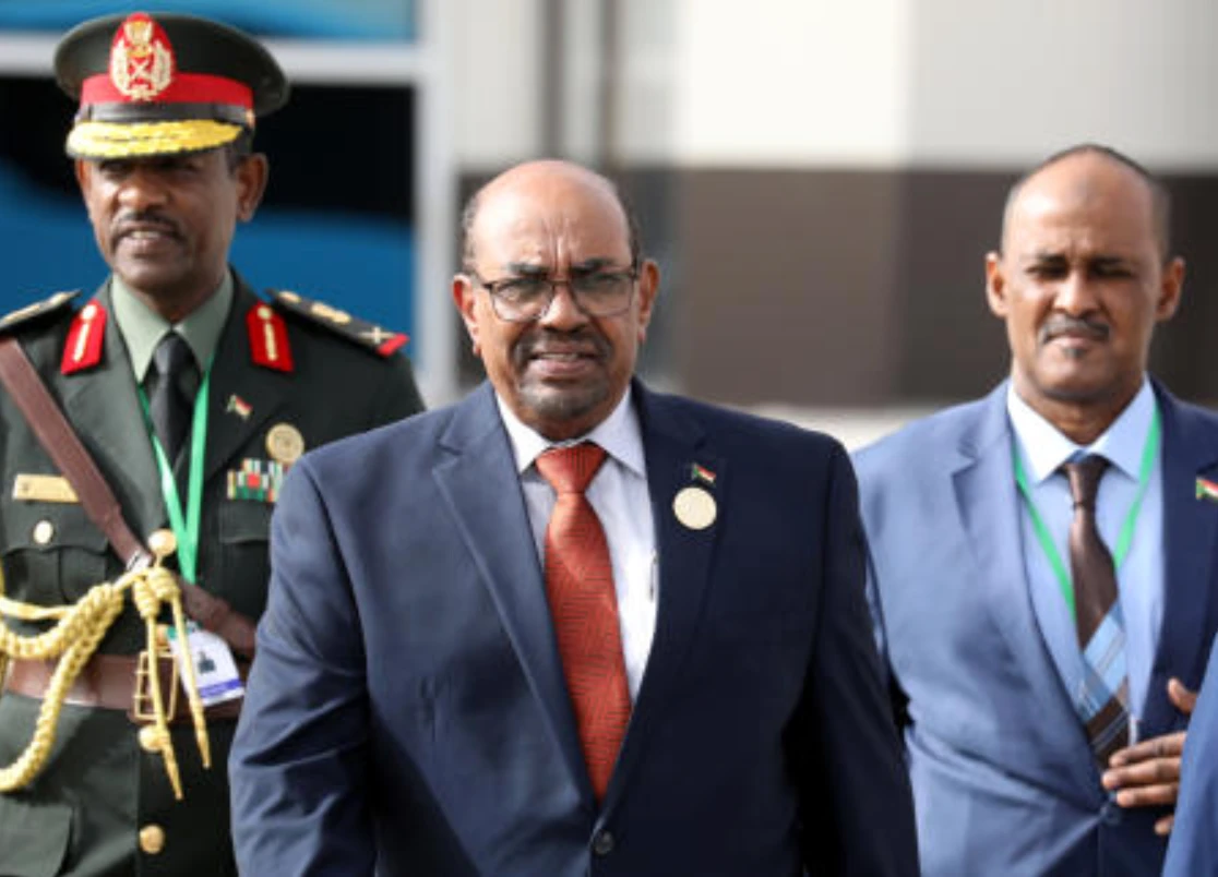 Sudanese President Omar al-Bashir walks with officials as he leaves an African Union summit in Nouakchott, Mauritania. (Reuters)