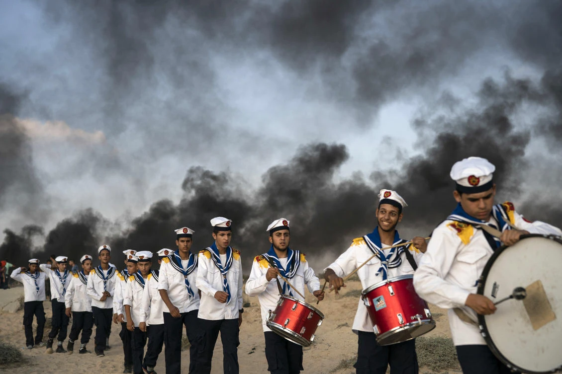 Palestinian boy scouts march during a protest on the beach near the border with Israel in Beit Lahiya, northern Gaza Strip, Monday, Sept. 10, 2018. (AP)