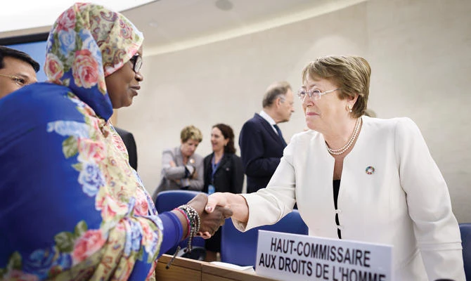 New High Commissioner for Human Rights Michelle Bachelet, right, welcomes delegates upon her arrival on the opening day of 39th UN Council of Human Rights in Geneva on Monday. (AFP)
