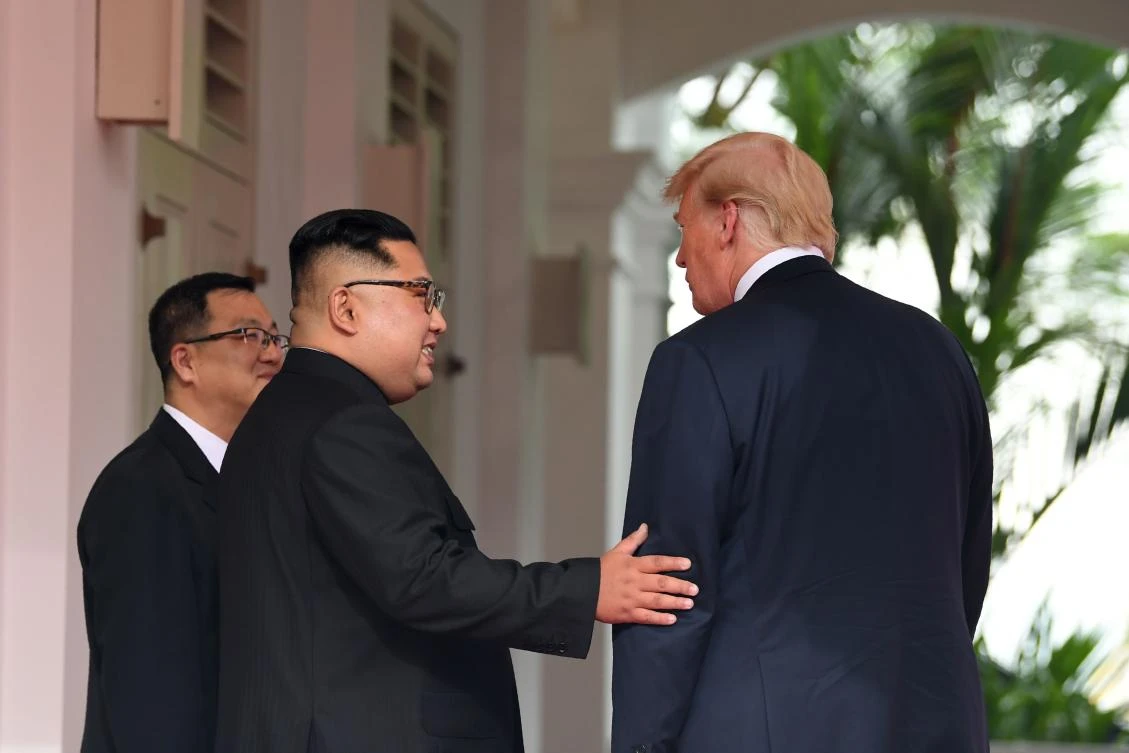 North Korea’s leader Kim Jong Un (C) gestures as he meets with US President Donald Trump (R) at the start of their historic US-North Korea summit, at the Capella Hotel on Sentosa island in Singapore. (File/AFP)