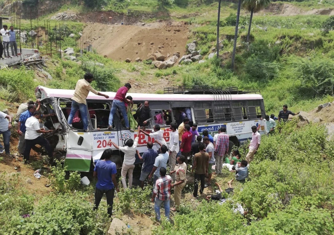 Rescuers pull out passengers from a bus that fell into a gorge in Jagtiyal district of Telangana, India, Tuesday, Sept. 11, 2018. (AP)