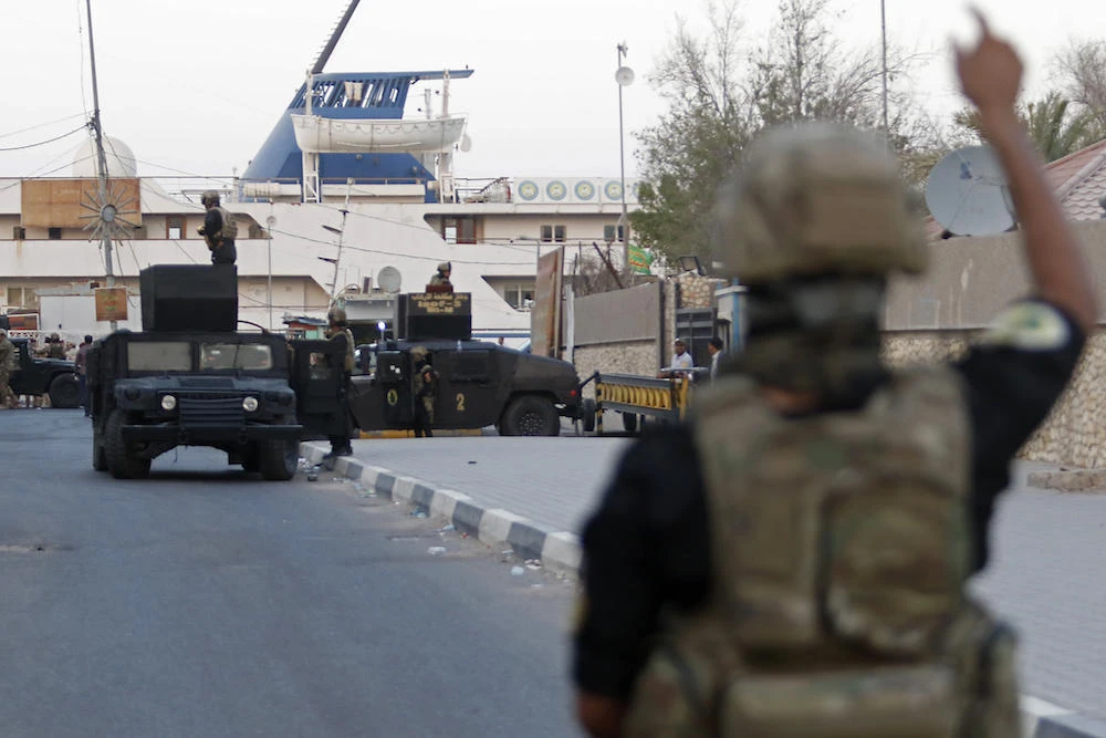 Iraqi Counter-Terrorism Services (CTS) members secure the street close to the Basra International Hotel where Iraqi Prime Minister Haider Al-Abadi stays in Basra. (AFP)
