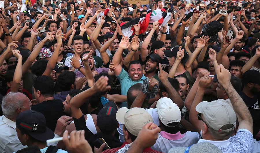 Iraqis demonstrate in Tahrir Square in central Baghdad. 3 mortar shells hit late the green zone, which houses the US Embassy. (AFP)