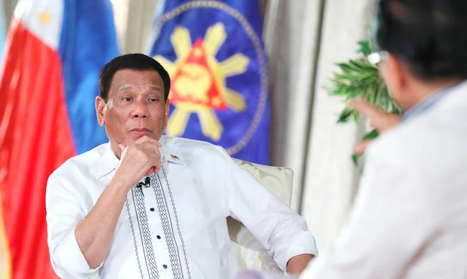 In this photo released by the Malacanang Presidential Photographers Division, Philippine President Rodrigo Duterte, left, listens to a question from Chief Presidential legal counsel Salvador Panelo during a state TV talk show at the Malacanang presidential palace in Manila, Philippines, on Tuesday Sept. 11, 2018. (AP)