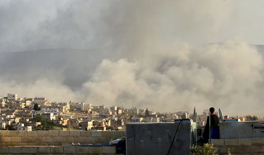 A man watches as smoke rises after what activists said was an air strike on Atimah, Idlib province March 8, 2015. (REUTERS)