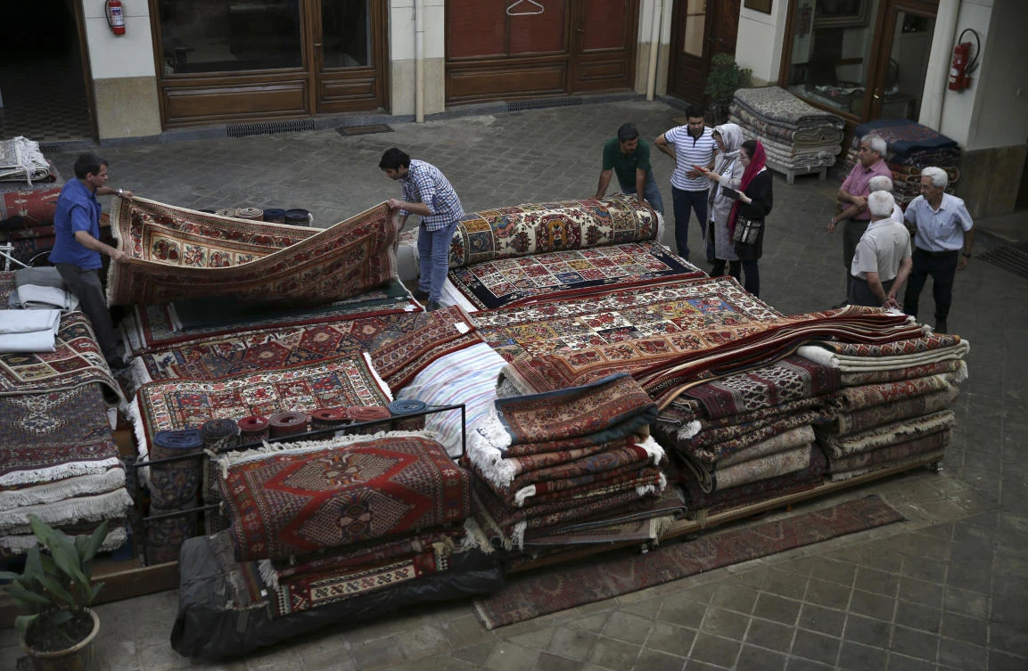 In this Monday, Aug. 13, 2018 photo, people shop for carpets at the Grand Bazaar in Tehran, Iran. (AP)