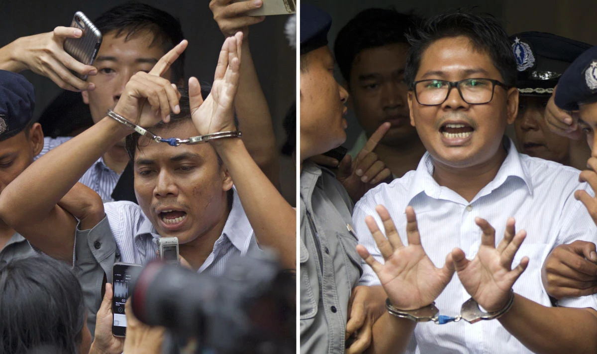 In this combination image made from two photos, Reuters journalists Kyaw Soe Oo, left, and Wa Lone, are handcuffed as they are escorted by police out of the court Monday, Sept. 3, 2018, in Yangon, Myanmar. (AP)