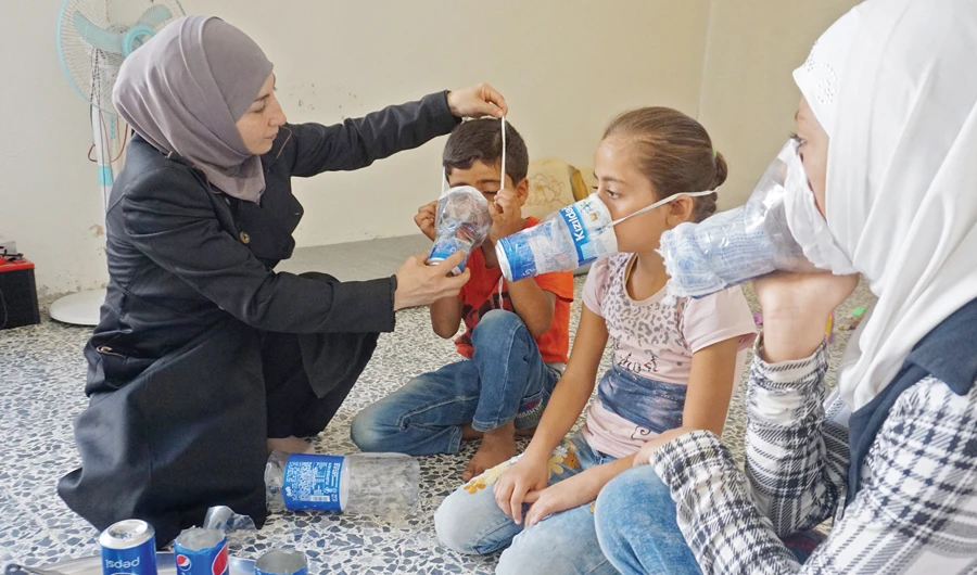 Syrian families are trying out improvised gas masks in Idlib province as part of preparations for a military offensive. (File/AFP)