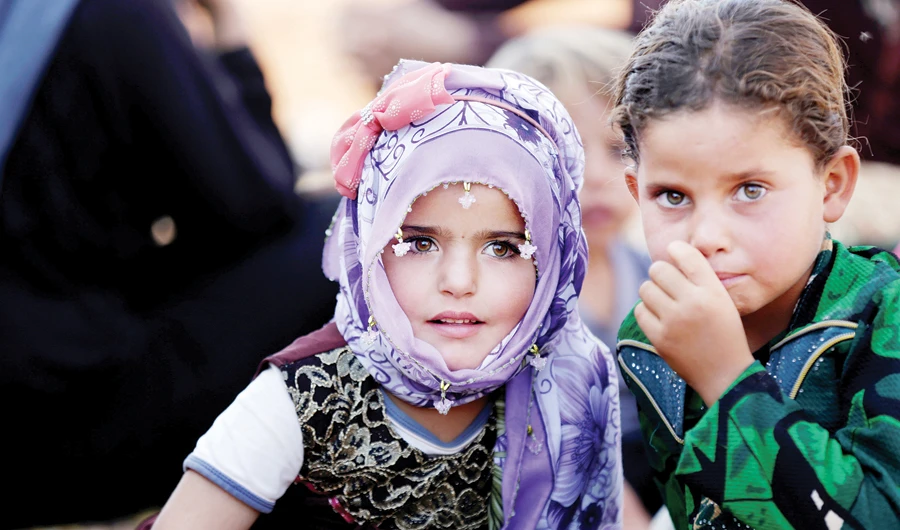 Syrian children react after arriving at a refugee camp in Idlib. (File/Reuters)