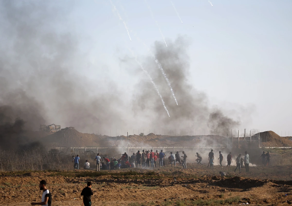 Israeli forces fire tear gas at Palestinian protesters during a demonstration along the Israeli fence East of Gaza City on September 14, 2018. (AFP)