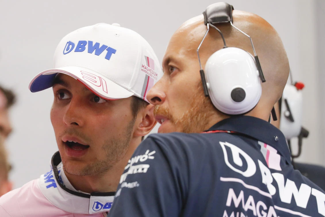 Force India driver Esteban Ocon of France talks with team mechanic during second practice at the Marina Bay City Circuit ahead of the Singapore Formula One Grand Prix in Singapore, Friday, Sept. 14, 2018. (AP Photo/Vincent Thian)