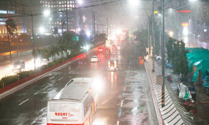 Motorists brave the rain and strong winds brought about by Typhoon Mangkhut which barrelled into northeastern Philippines before dawn Saturday, Sept. 15, 2018 in Manila, Philippines. (AP)