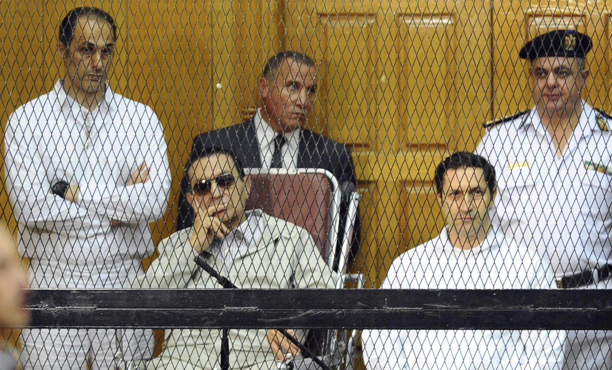 In this Sept. 14, 2013 file photo, former Egyptian President Hosni Mubarak, seated center left, and his two sons, Gamal Mubarak, left, and Alaa Mubarak attend a hearing in a courtroom in Cairo, Egypt. (AP)