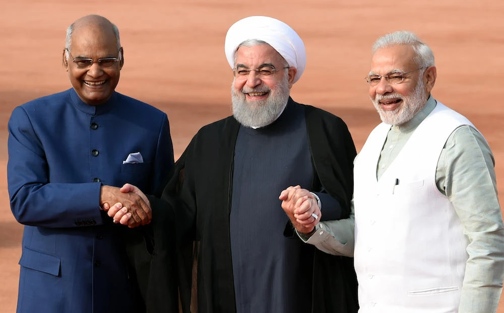 Iranian President Hassan Rouhani (C) holds hands with Indian President Ram Nath Kovind (L) and Indian Prime Minister Narendra Modi (R) during a ceremonial reception at the Indian Presidential palace in New Delhi. (File Photo / AFP)