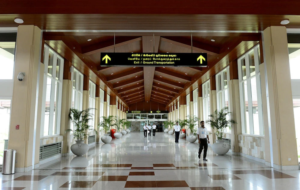 Sri Lankan workers walk in a corridor at the international airport at Hambantota. (File photo / AFP)