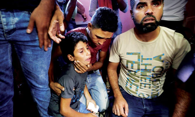 The twin brother of 11-year-old Shadi Abdel-Al, who was killed by Israeli forces, mourns during his funeral in Gaza. (Reuters)