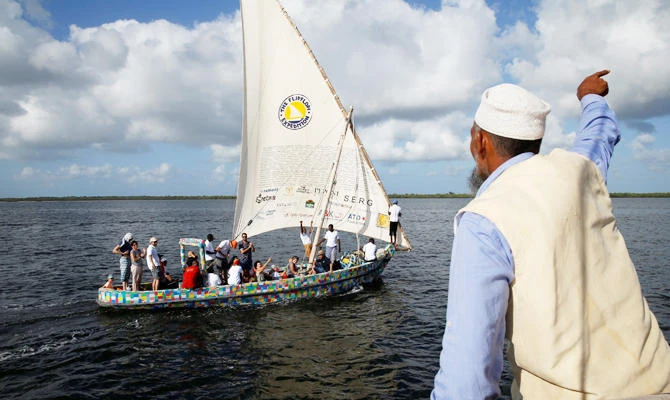 Master boat builder Ali Skanda gestures to people on board Flipflopi, the first dhow boat made entirely of recycled plastic after the launch ceremony on the island of Lamu, Kenya, September 15, 2018. (REUTERS)