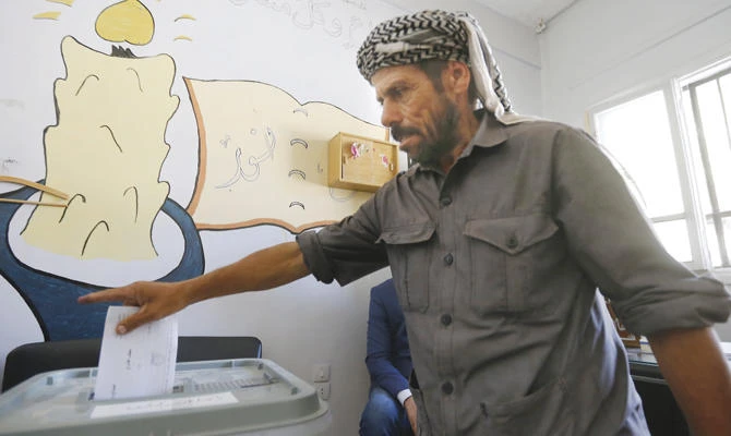 A man casts his ballot for Syria's local elections in southern Eastern Ghouta. (AFP)