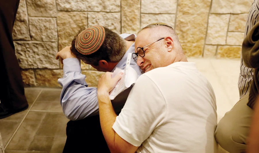The brothers of Ari Fuld, 45, an American-born Jewish settler fatally stabbed by a Palestinian, mourn during his funeral on Sunday. (Reuters )