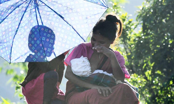 This photo taken on July 11, 2018 shows an Indian mother with her children in Kongthong village, in East Khasi Hills district in India's eastern Meghalaya state. (AFP)