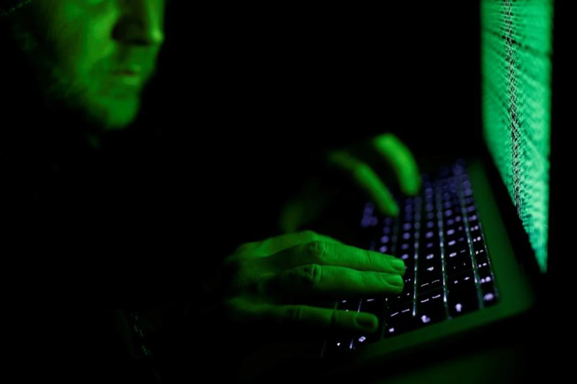 A man types on a computer keyboard in front of the displayed cyber code in this illustration picture taken on March 1, 2017. (Reuters)