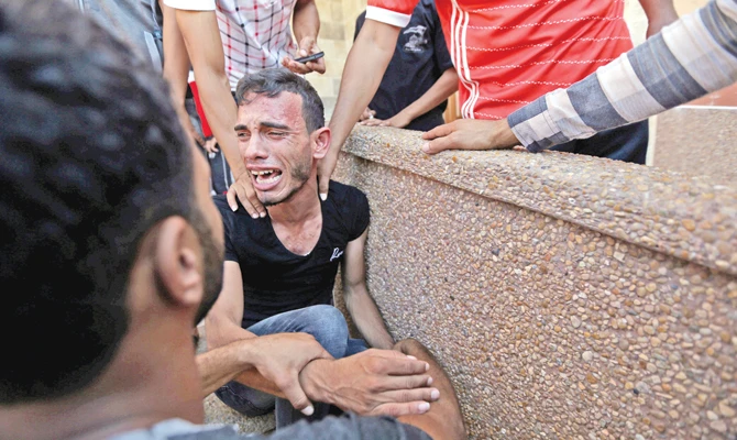 A relative of Palestinians killed by Israel reacts in Gaza. (Reuters)