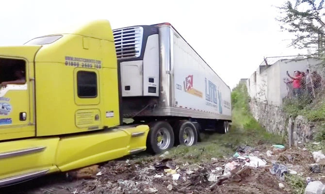 A truck leaves with an abandoned trailer full of bodies that has been parked in Tlajomulco de Zuniga, Jalisco, Mexico, in this September 15, 2018 photo, in this still image taken from a video obtained September 17, 2018. (REUTERS)