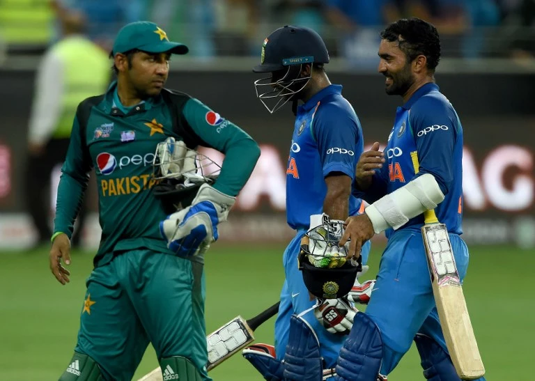 Pakistan's captain Sarfraz Ahmed, left, leaves the field followed by India's Dinesh Karthik, right, and Ambati Rayudu at the end of the one day international match in the Asia Cup between India and Pakistan in Dubai. (AFP)