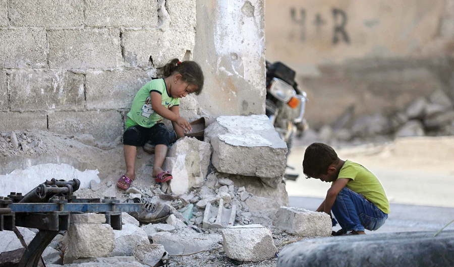 Syrian children play in Morek, a town in the northern countryside of Hama province in neighboring Idlib province to the north, on Tuesday. (AFP)
