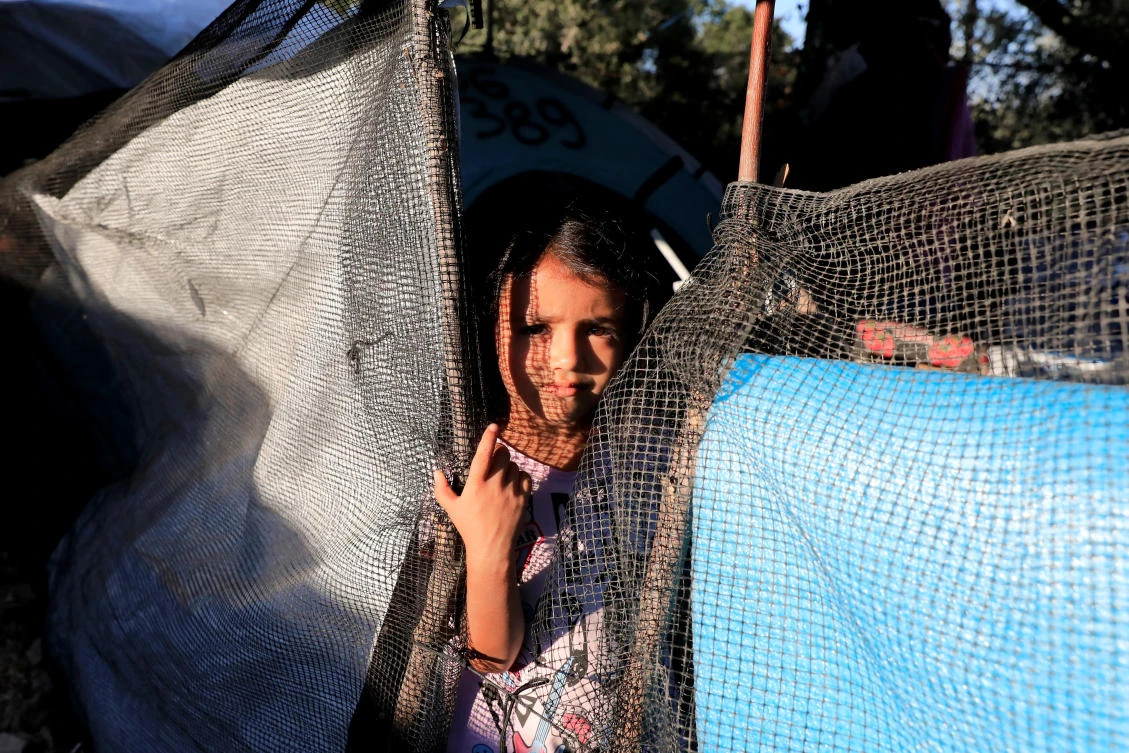 A migrant girl looks on at a makeshift camp next to the Moria camp for refugees and migrants on the island of Lesbos, Greece, September 17, 2018. Picture taken September 17, 2018. (Reuters)