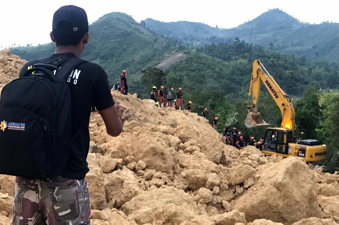Rescuers search for survivors after a landslide set off by heavy rains struck a village in Naga city, central Philippines on Thursday September 20. (AP)