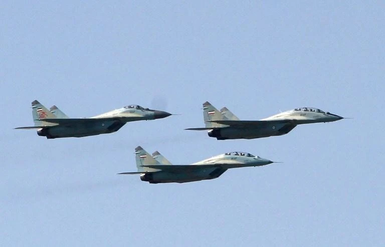 Russian-made Sukhoi fighter jets, above, are part of Iran’s air force drill near the Strait of Hormuz in the Arabian Gulf, the passageway for nearly a third of all oil traded by sea. (AFP)