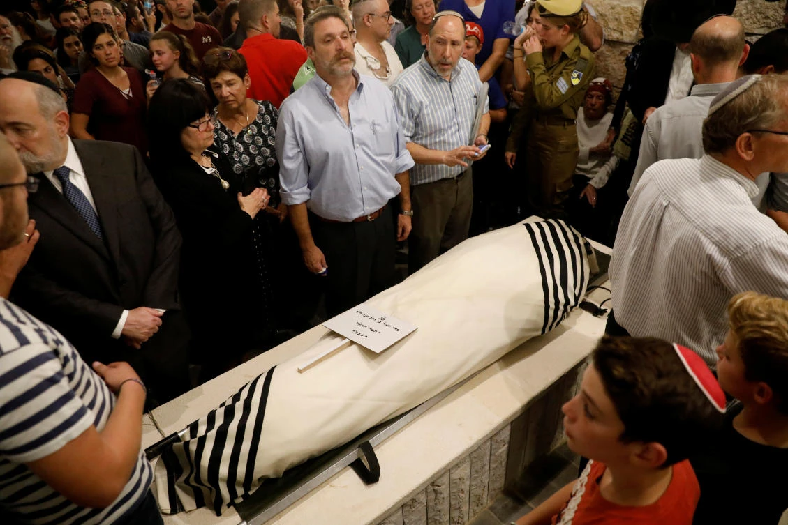 Relatives and friends mourn during the funeral of Ari Fuld, 45, at a cemetery in Kfar Etzion in the occupied West Bank September 17, 2018. (Reuters)
