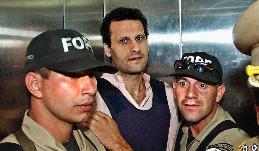 In this file photo, Lebanese citizen Assad Ahmad Barakat, who was then facing tax evasion charges, is escorted by police to a courthouse in Asuncion, Paraguay. (AP)