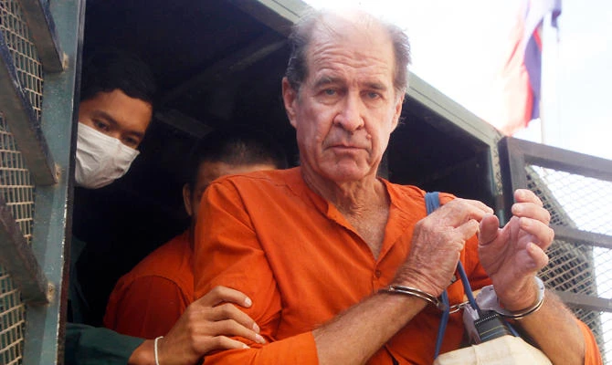 In this Aug. 29, 2018, file photo, Australian filmmaker James Ricketson, right, is helped off a prisoner truck upon his arrival at Phnom Penh Municipal Court in Phnom Penh, Cambodia. (AP)