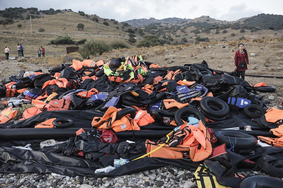 Life vests and inflatable boats that were carrying Syrian refugees lie on a heap on the shore of Lesbos island in Greece. (File/AFP)