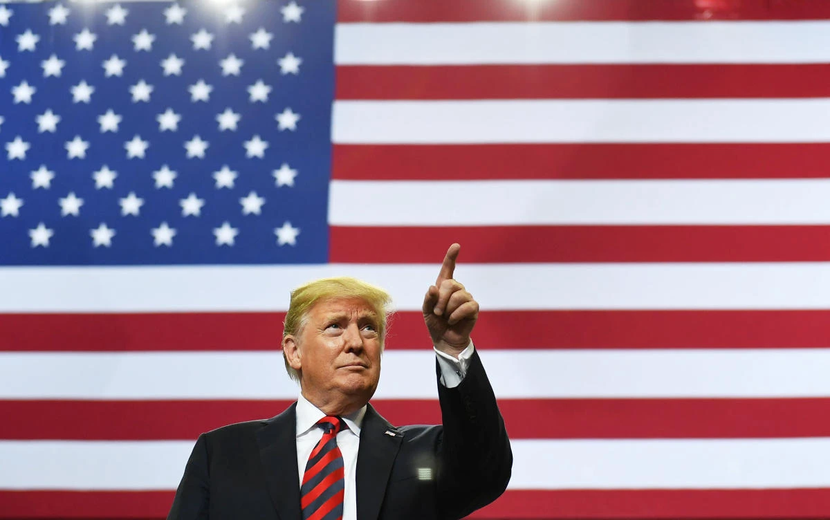US President Donald Trump arrives on stage to speak at a rally at JQH Arena in Springfield, Missouri on September 21, 2018. (AFP)