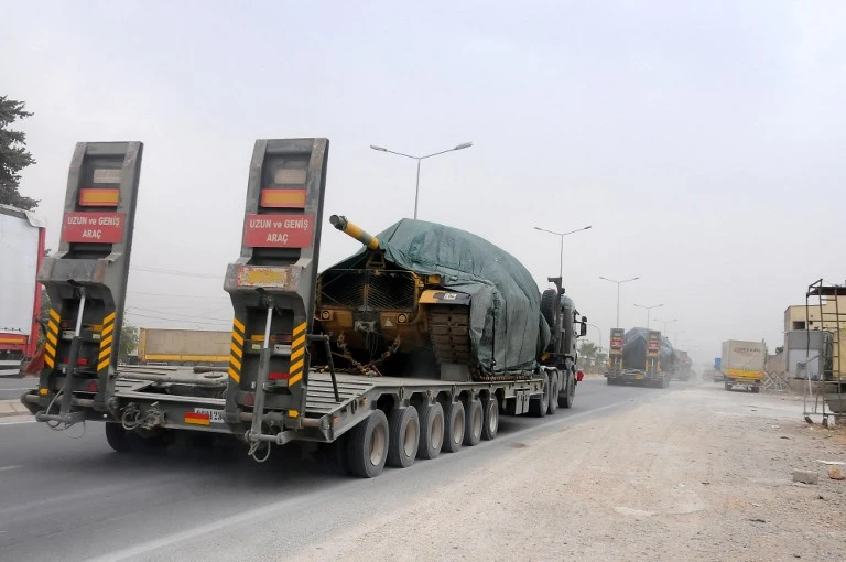 A Turkish military truck carries tanks as it drives towards the Syrian border on September 13. (AFP)
