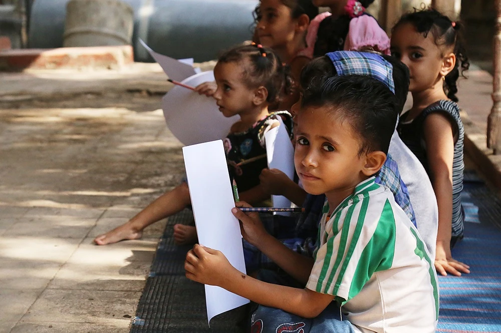 Yemeni children attend a makeshift reading and writing class in the country's third-largest city Taez on September 3, 2015. (File/AFP)