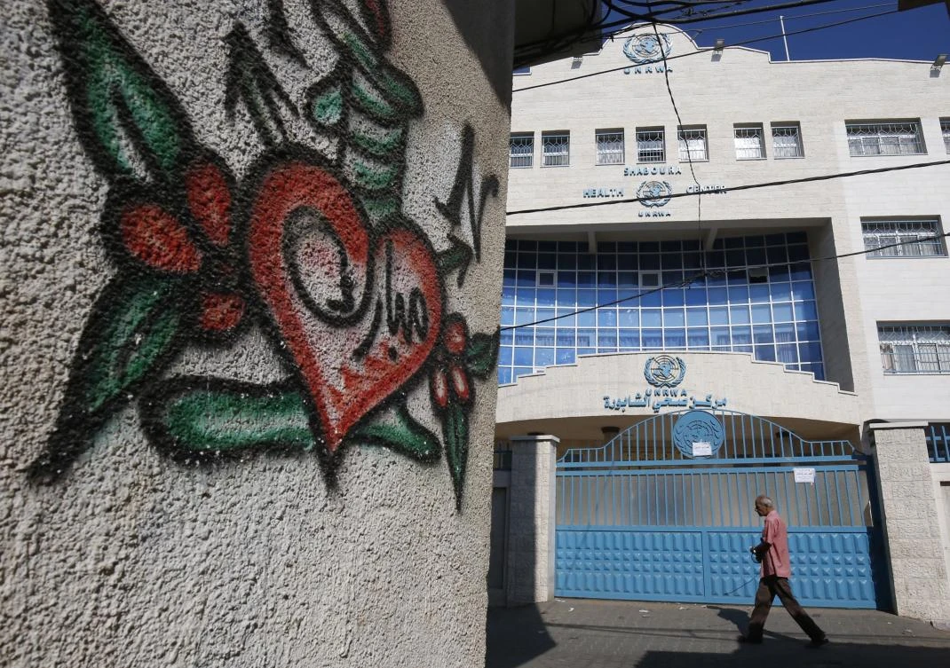 A Palestinian man walks past a closed health centre that run by United Nations Relief and Works Agency (UNRWA) during a strike of all UNRWA institutions in Rafah in the southern Gaza Strip on September 24, 2018. (AFP)