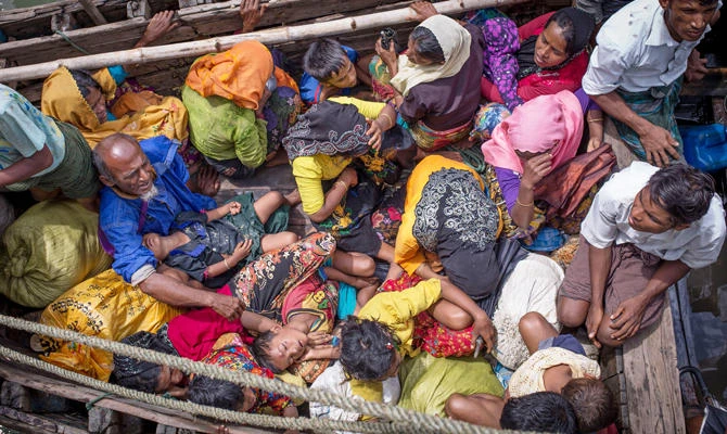 This photo taken on September 12, 2017 shows Rohingya refugees arriving by boat at Shah Parir Dwip on the Bangladesh side of the Naf River after fleeing violence in Myanmar. (AFP)