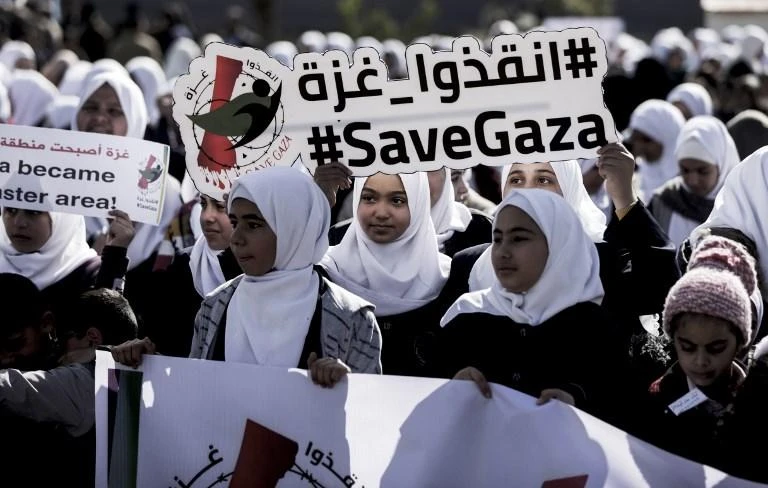 Palestinian schoolchildren a protest Gaza city on February 4, 2018, against the difficult economic situation and the US decision to withhold funds earmarked for the UN relief agency for Palestinian refugees. (AFP)