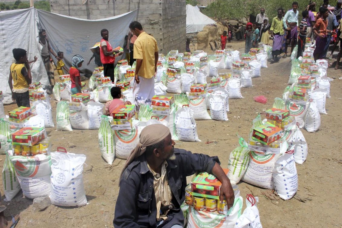The UN’s World Food Program sent trucks carrying 10,000 food packages to Aslam district, each meant to feed one family for a month. (AP)